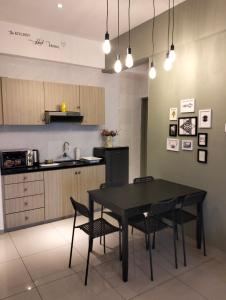 a kitchen with a table and chairs in a room at Homestay Melaka at Mahkota Hotel - unit 3093 - FREE Wifi & Parking in Malacca