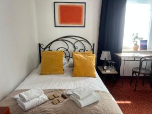 1 dormitorio con 1 cama con toallas en Villa Admiral, en Gdynia