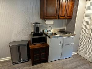 a small kitchen with a sink and a coffee maker at Mid-Century DJs Dream near Rhinebeck 