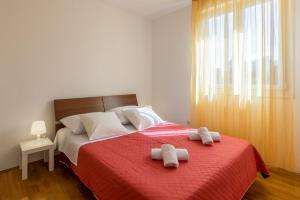 a bedroom with a bed with two towels on it at Hana City Apartment in Split