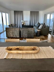 a living room with a couch and a table at Thyme & Tide Beach Villa in Yzerfontein