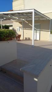 a patio with awning in front of a building at SALENTO AT HOME in Nardò