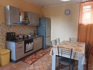 a kitchen with a table and a table and a table and a table at CASA VACANZA DEL SOLE in Milo