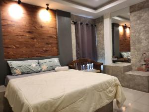 een slaapkamer met een groot bed en een bad bij Loft House Resort Pattaya in Jomtien Beach