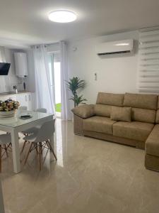 a living room with a couch and a table at VIVIENDA RURAL EL PROGRESO in Carchelejo