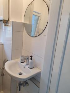 a bathroom with a sink and a mirror at ST3 Apartment in Triberg
