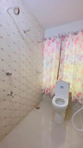 a small bathroom with a toilet and a shower at Hotel Rose Haven Residential in Dhaka