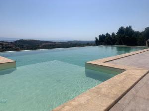 a swimming pool with a view of the water at ST NIKOLA PANORAMIC SUITES HALKIDIKI in Agios Nikolaos