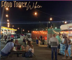 a group of people at a food truckilion at night at Family-Home-Workplace-Peace in Arecibo