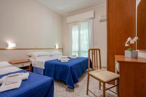 Postel nebo postele na pokoji v ubytování Hotel Stella Del Mare