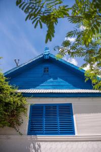 a blue and white building with a window at Pensiunea La Gura Portitei - Jurilovca in Jurilovca