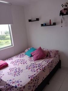 a bedroom with a bed with purple sheets and a window at Apto Agradable y Fresco en Conjunto Cerrado Decimo Piso in Neiva