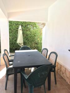 a black table and chairs on a patio at Quinta de S Joao by Villas Key in Lagoa