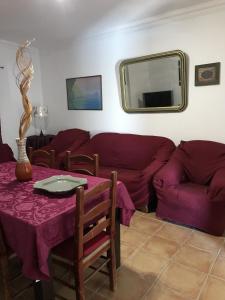 a living room with a table and a couch at Quinta de S Joao by Villas Key in Lagoa