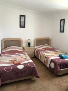 two beds sitting next to each other in a bedroom at Quinta de S Joao by Villas Key in Lagoa +12 photos