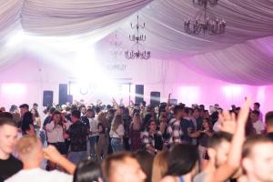 a large crowd of people standing in a pink room at Boutique Hotel ,,Villa Franca'' in Sighişoara
