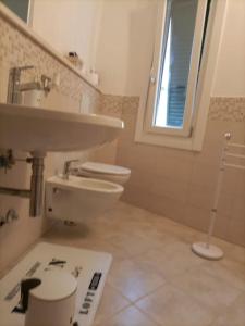 a bathroom with a sink and a toilet at Appartamento Casa Margi in Ameglia