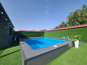 a swimming pool in a yard with a wooden deck at Дачный массив Кайнар Булак. г. Шымкент in Kaynarbulak