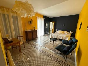 a bedroom with a bed and a table and chairs at Les Terrasses in Montéglin
