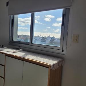 a window with a view of a city at Luminoso Monoambiente Zona Universitaria 5to piso in La Plata