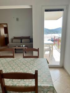 a living room with a table and chairs and a couch at Apartment Kustura in Vinišće