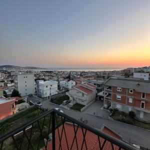a view of a city at sunset from a balcony at Akapulco Apartments in Bar