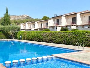 a swimming pool in front of a building at Kalma House in Torroella de Montgrí