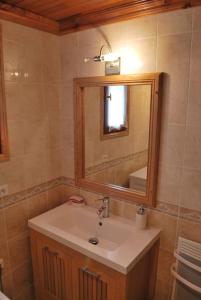 a bathroom with a sink and a mirror at Chalet savoyard By the Rock in Villaroger