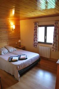 a bedroom with a bed with two pillows on it at Chalet savoyard By the Rock in Villaroger