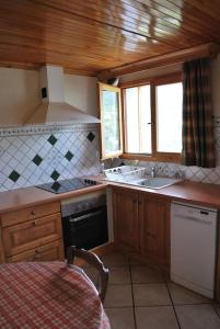 a kitchen with a sink and a stove top oven at Chalet savoyard By the Rock in Villaroger