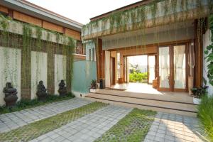 an external view of a building with a courtyard at Balcony Living Apartment in Seminyak