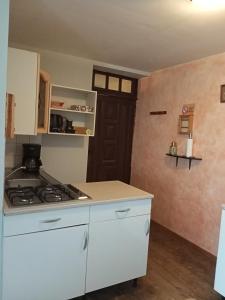 a kitchen with a stove and a white counter top at chez christine in Sainte-Marie