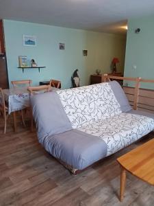 a large couch in a living room with a table at chez christine in Sainte-Marie