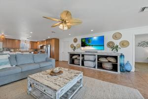 a living room with a couch and a table at The Turtle Dolphin in Port Aransas