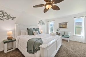 a white bedroom with a bed and a ceiling fan at The Turtle Dolphin in Port Aransas +75 photos