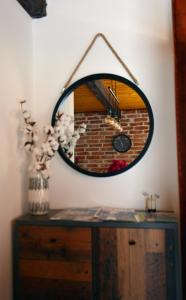 a mirror sitting on top of a wooden dresser at Kuća za odmor Čanić gaj in Gospić