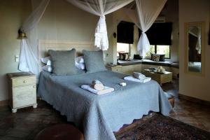 a bedroom with a bed with towels on it at Eden Safari Country House in Marloth Park +34 photos