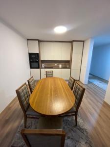 a conference room with a wooden table and chairs at APARTMENT Ortakoll prizren 2 bedroom in Prizren