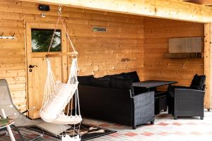 a log cabin with a hammock and a table at Haus-am-Sonnenweg in Lackenhof