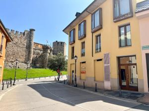 an empty street in front of a castle at El mirador templario in Ponferrada