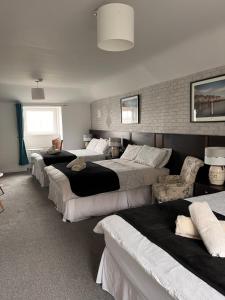 a group of four beds in a room at The Light House in Galway