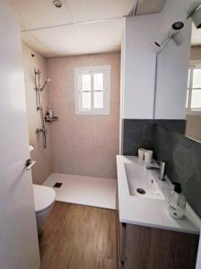 a bathroom with a white sink and a toilet at Enjoy the historic center of Chiclana By C. Dreams in Chiclana de la Frontera