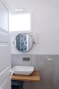 a bathroom with a sink and a mirror at Bisu Isola di Sant'Antioco in SantʼAntìoco