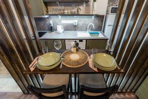 a small kitchen with a wooden table with glasses on it at Colors of Budapest in Budapest