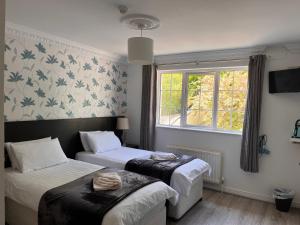 a room with two beds and a window at The Light House in Galway