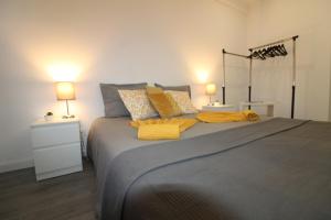 a bedroom with a large bed with two lamps at Varanda do Bonfim in Setúbal