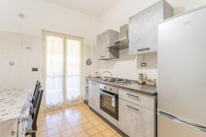 a kitchen with stainless steel appliances and a table at Come A Casa in Ostia Antica