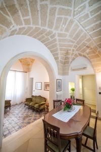 un soggiorno con tavolo e divano di Appartamento in palazzo storico a Lecce