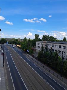 an empty highway in a city with buildings at Gingerbread Hostel in Toruń
