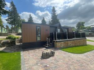 a small house with a stone sculpture in front of it at Martindale & Fusedale Lodge in Penrith